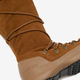 Close up of brown boots, showing texture of bovine Leather and goat skin fabric