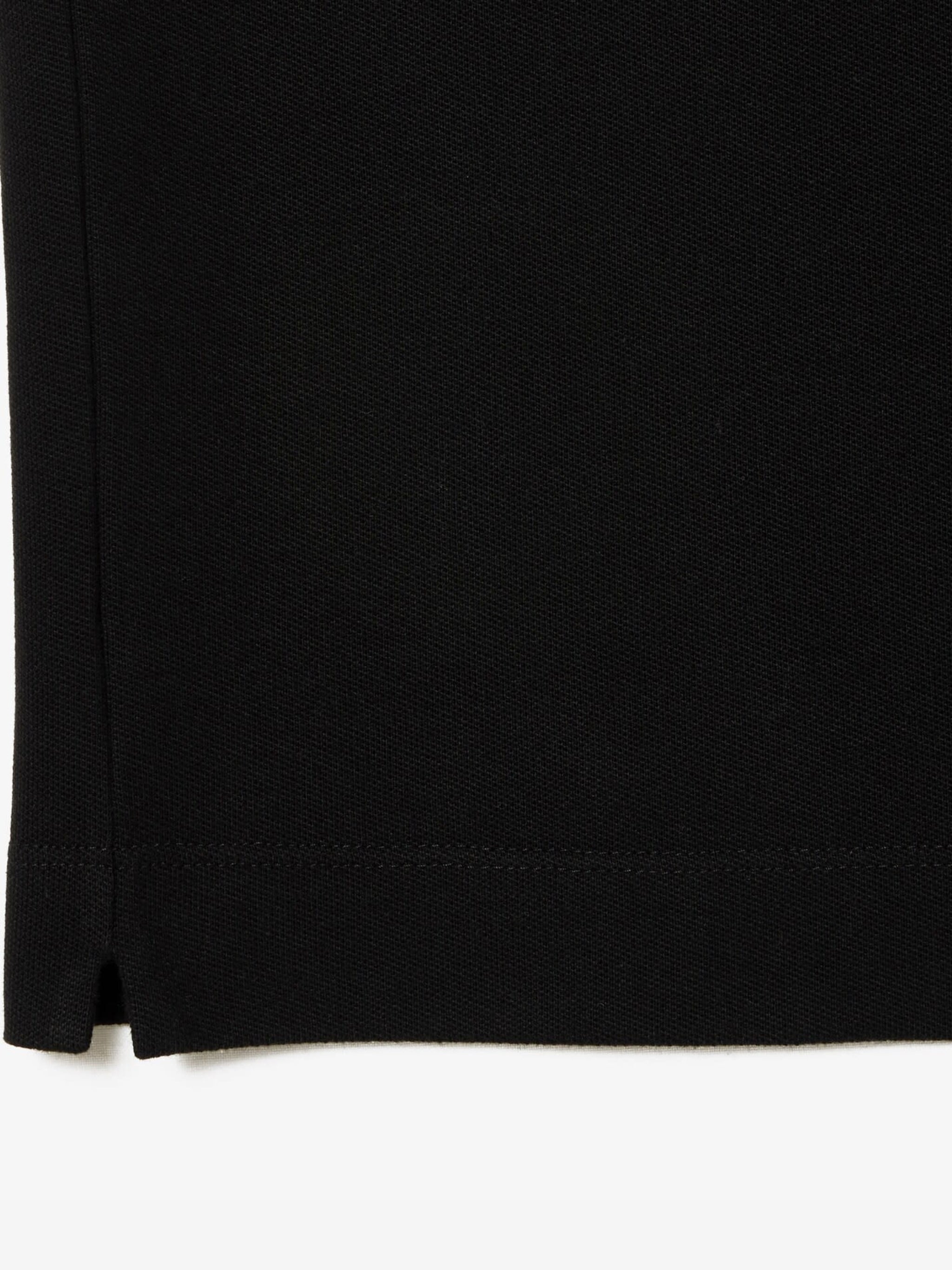 Close up of the black shirt, showing texture of the cotton fabric