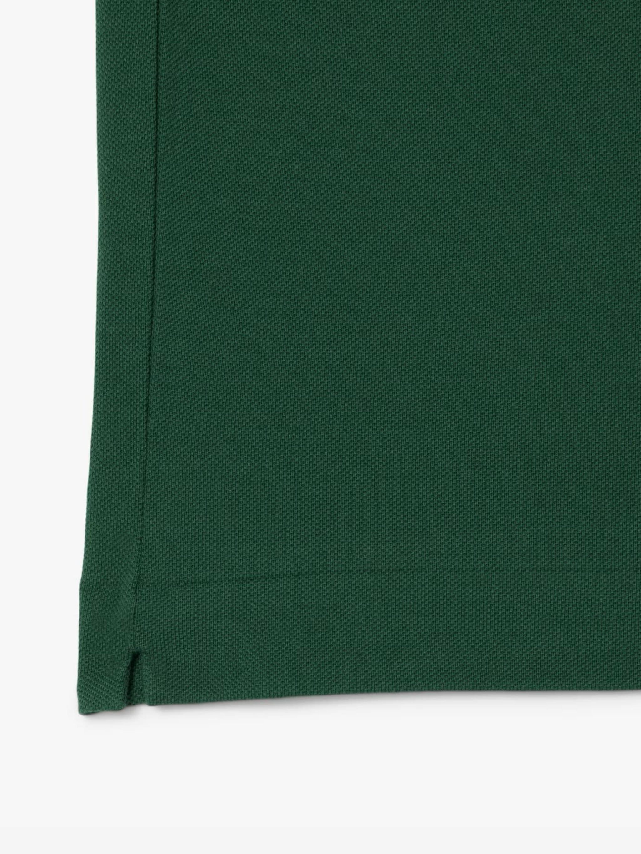 Close up of the green shirt, showing texture of the cotton fabric