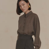 Purple shirt worn by a person, showing the shirt’s fit