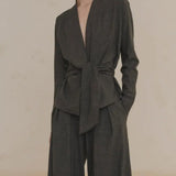 Close up of green jacket, showing texture of the virgin wool fabric