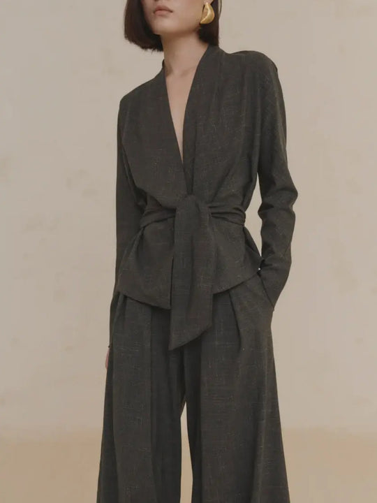 Close up of green jacket, showing texture of the virgin wool fabric