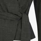 Close up of green jacket, showing texture of the virgin wool fabric