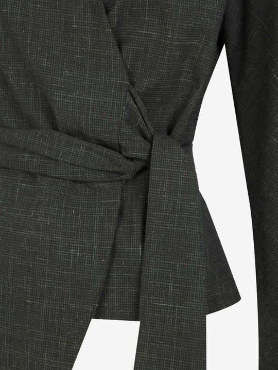 Close up of green jacket, showing texture of the virgin wool fabric