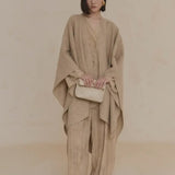 Tan coat worn by a person, showing the coat's fit