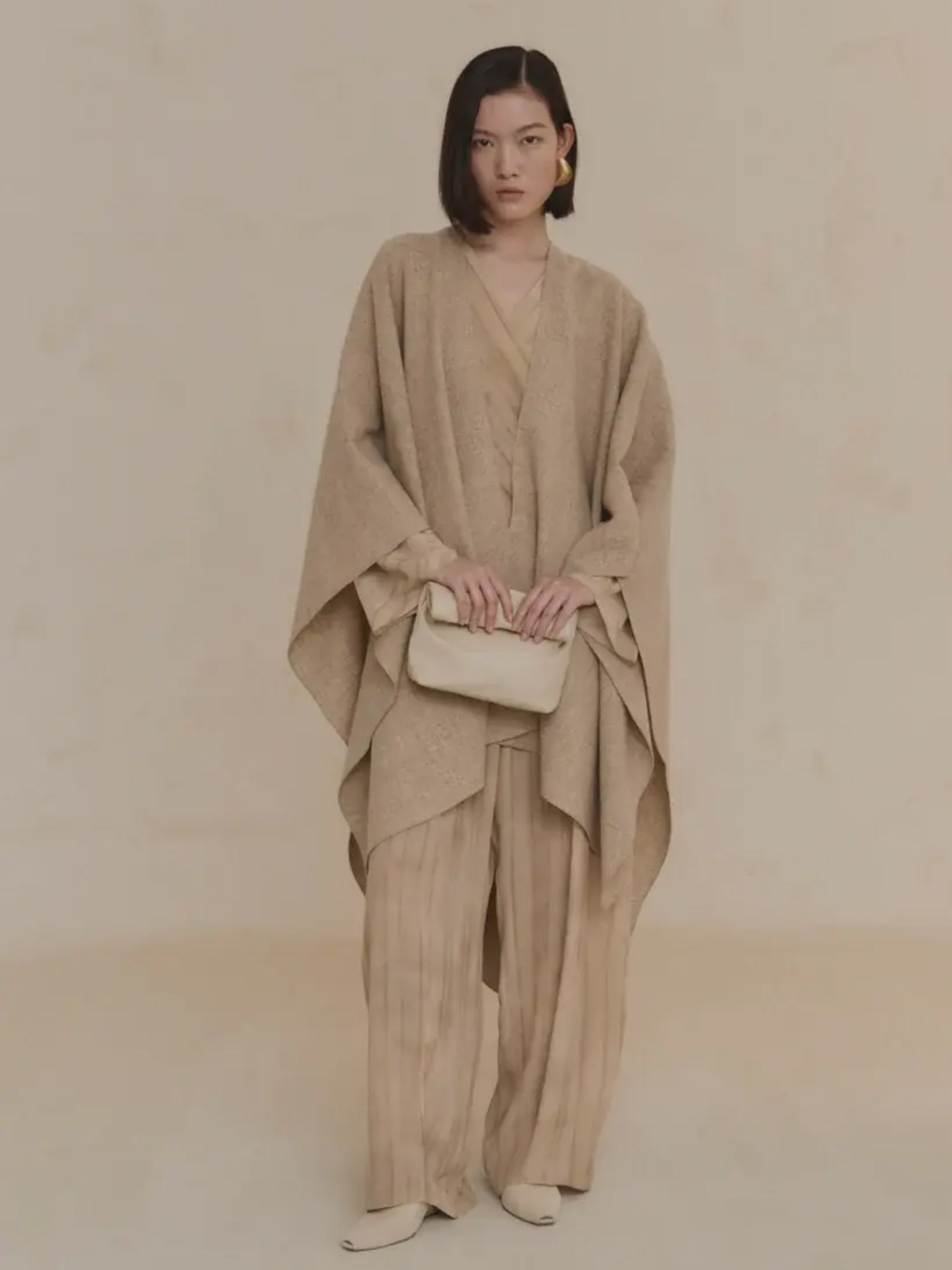 Tan coat worn by a person, showing the coat's fit