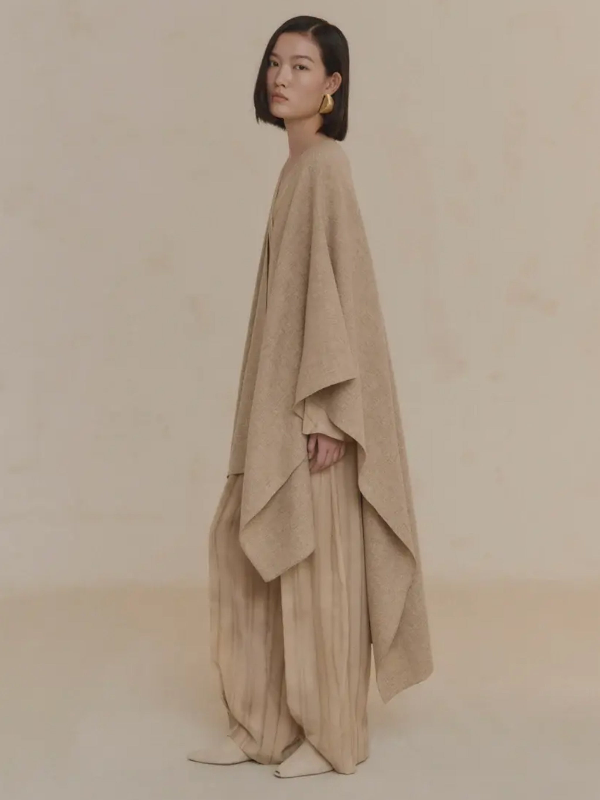 Tan coat worn by a person, showing the coat's fit