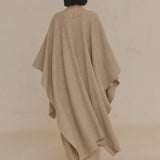 Tan coat worn by a person, showing the coat's fit