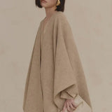 Close up of tan coat, showing texture of the wool fabric