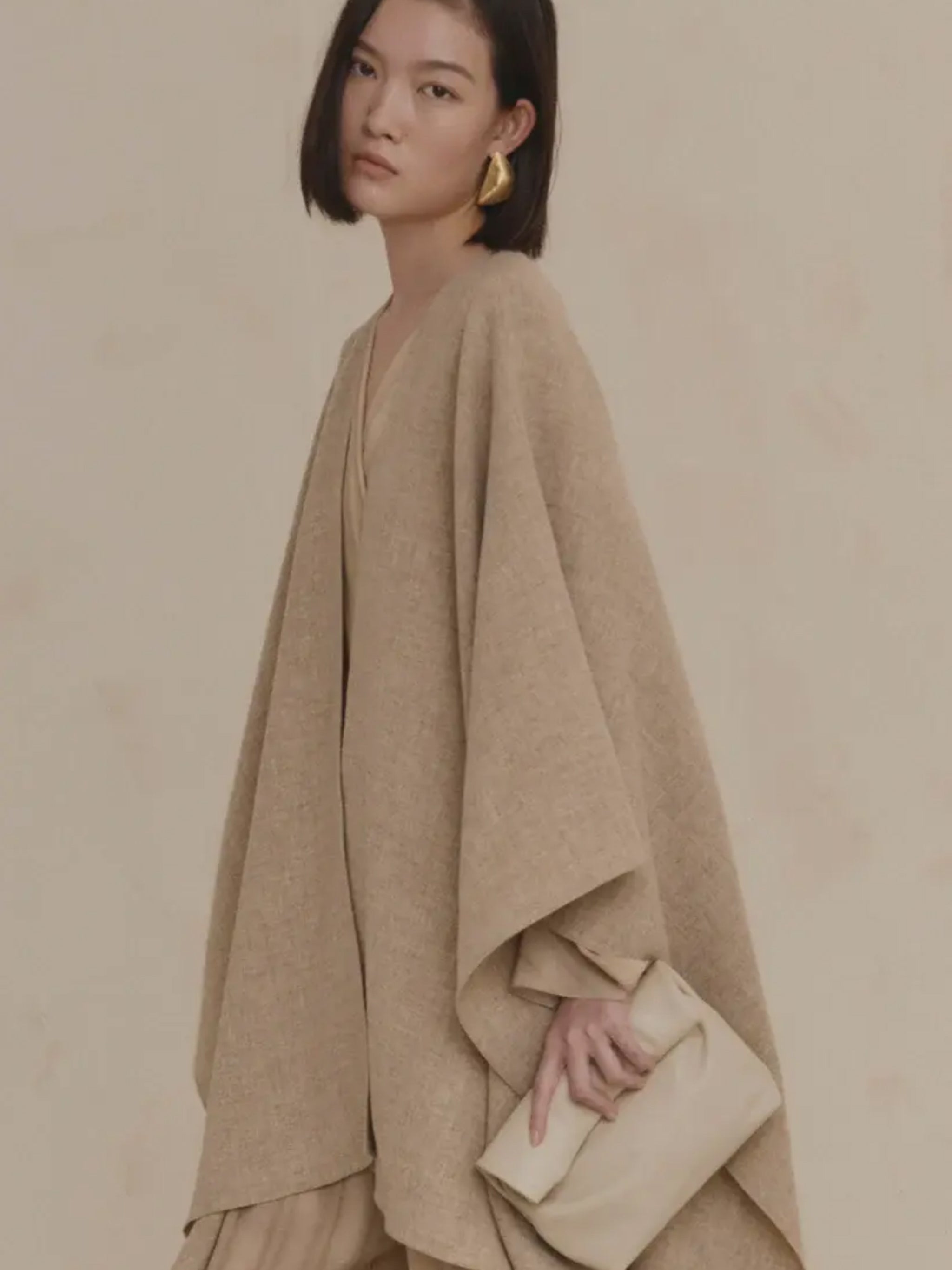 Close up of tan coat, showing texture of the wool fabric