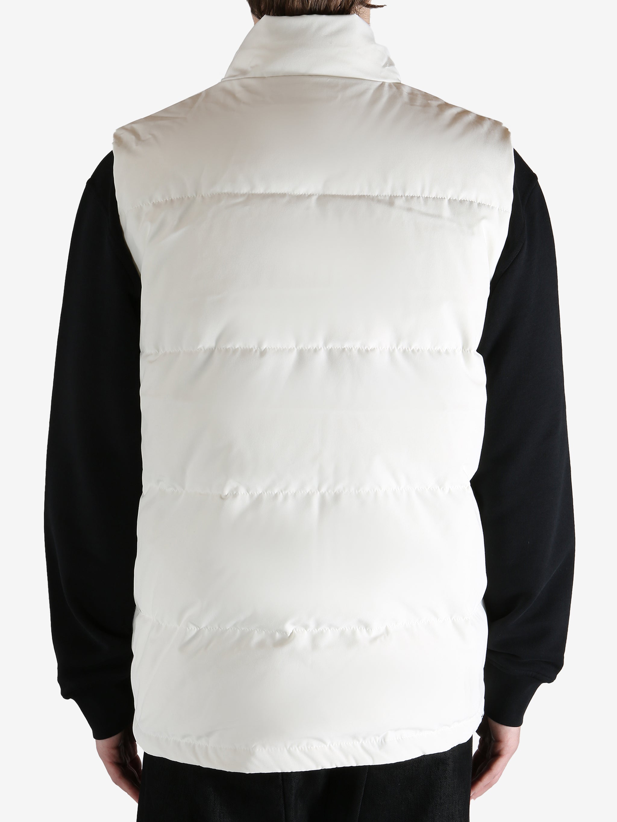 White vest worn by a person, showing the vest fit