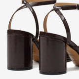 Close up of the brown sandal, showing texture of the leather fabric