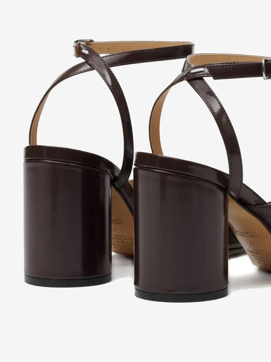 Close up of the brown sandal, showing texture of the leather fabric