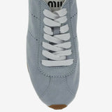 Close up of the blue sneakers, showing texture of the calf suede fabric