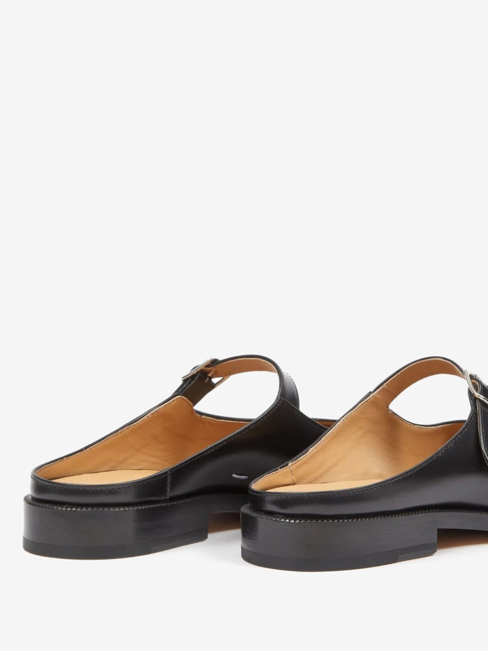 Close up of the black mule, showing texture of the leather fabric