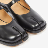 Close up of the black mule, showing texture of the leather fabric