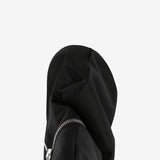 Close up of the black boot, showing texture of the leather fabric