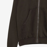 Close up of the brown hoodie, showing texture of the cotton fabric