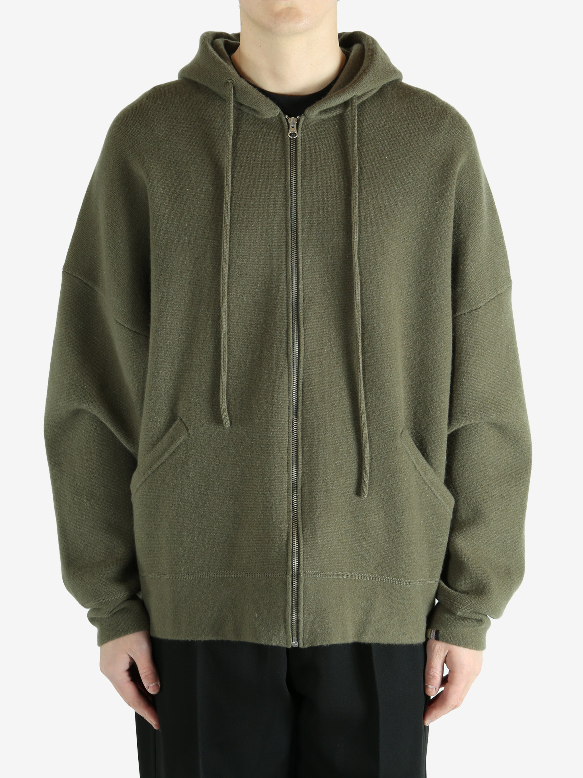 Green hoodie worn by a person, showing the hoodie's fit
