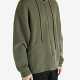 Green hoodie worn by a person, showing the hoodie's fit