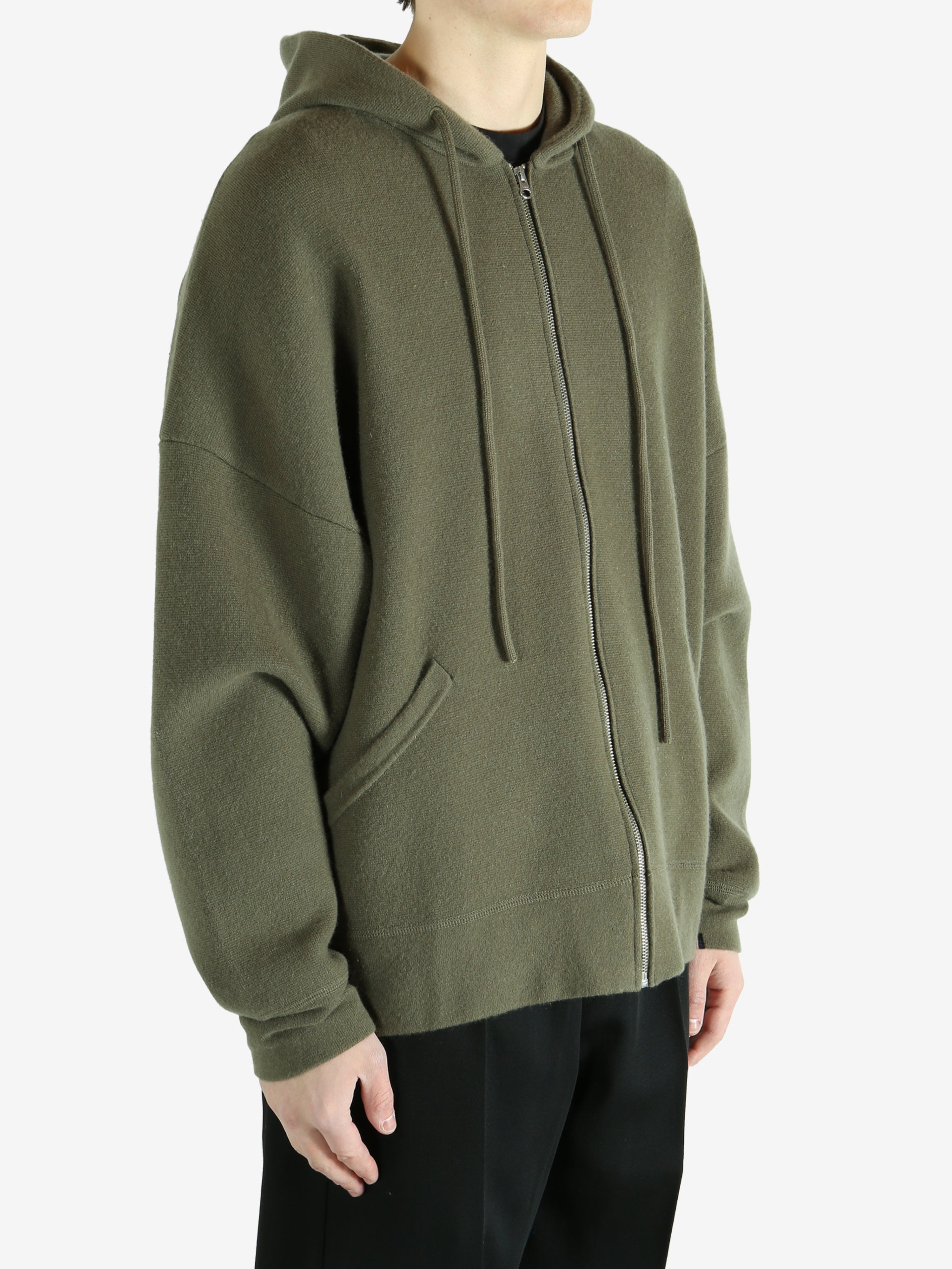 Green hoodie worn by a person, showing the hoodie's fit