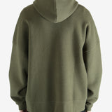 Green hoodie worn by a person, showing the hoodie's fit