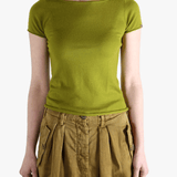 Green t-shirt worn by a person, showing the shirt's fit