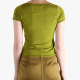 Green t-shirt worn by a person, showing the shirt's fit