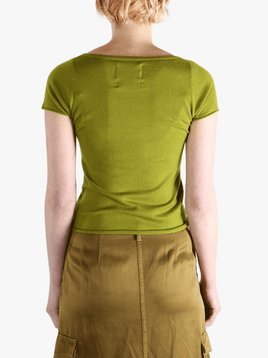 Green t-shirt worn by a person, showing the shirt's fit