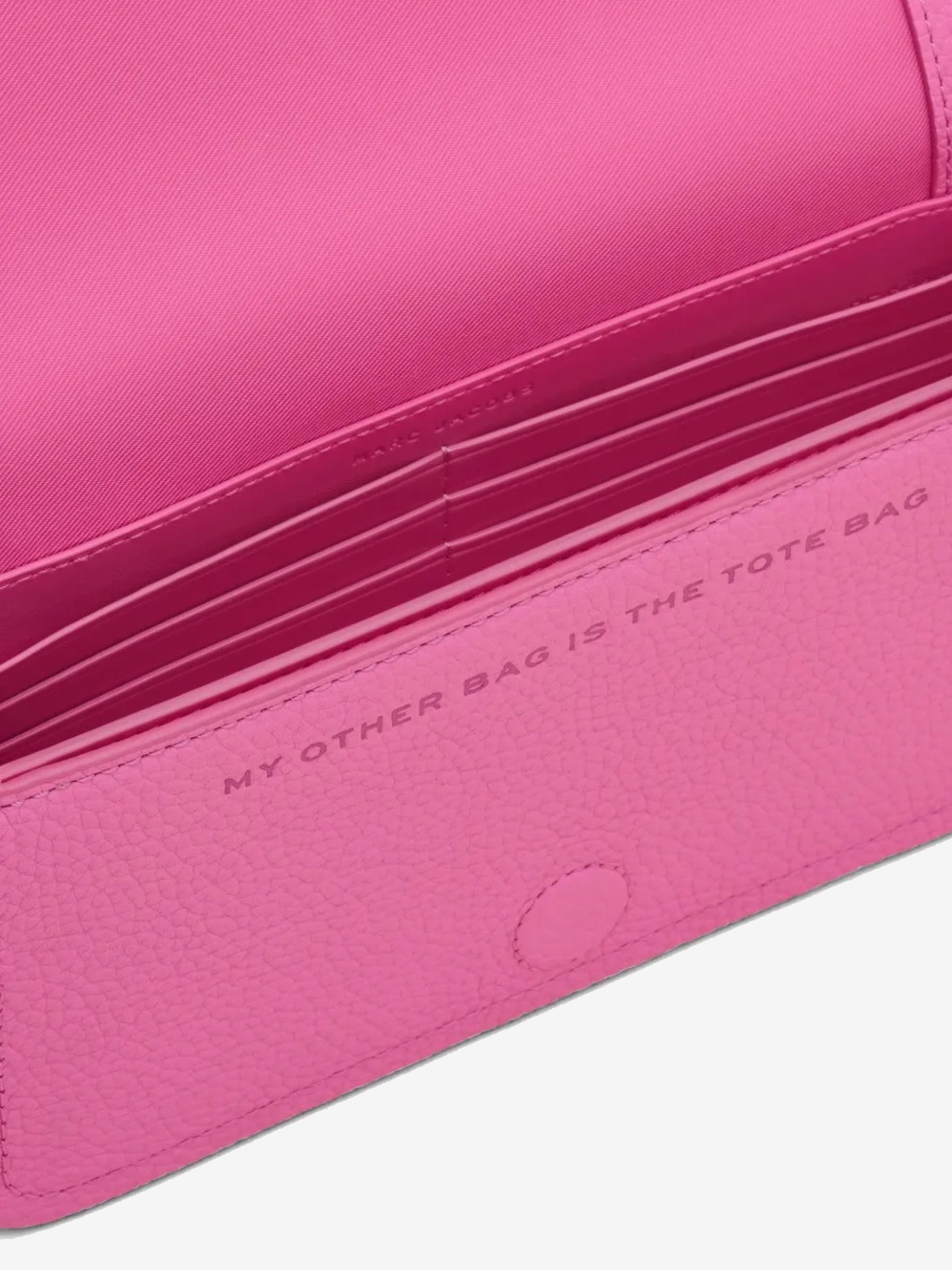 Close up of pink bag, showing texture of the leather fabric