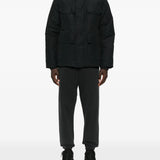 Black coat  worn by a person, showing the coat's fit