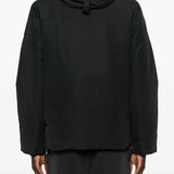 Black coat  worn by a person, showing the coat's fit