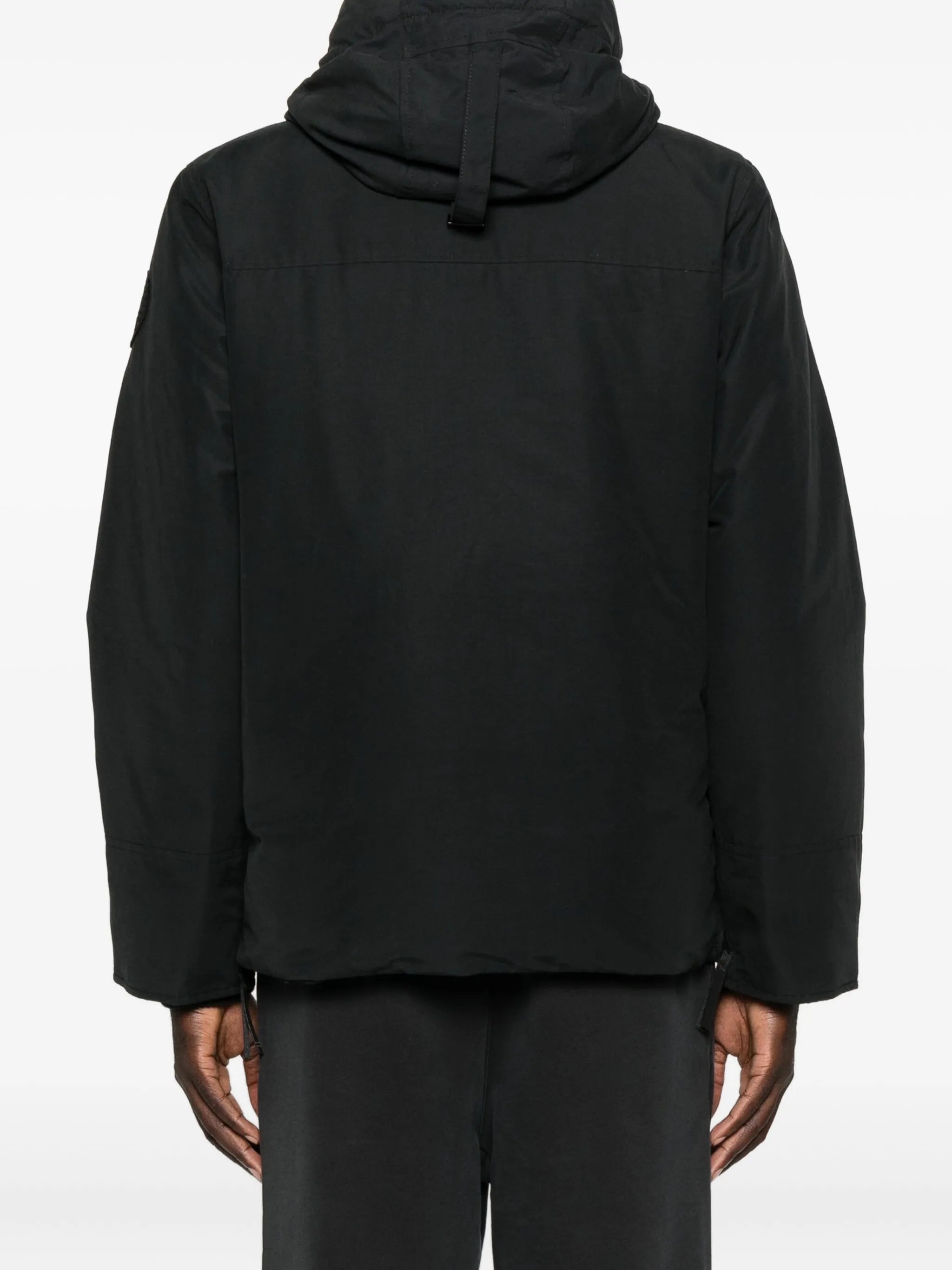 Black coat  worn by a person, showing the coat's fit