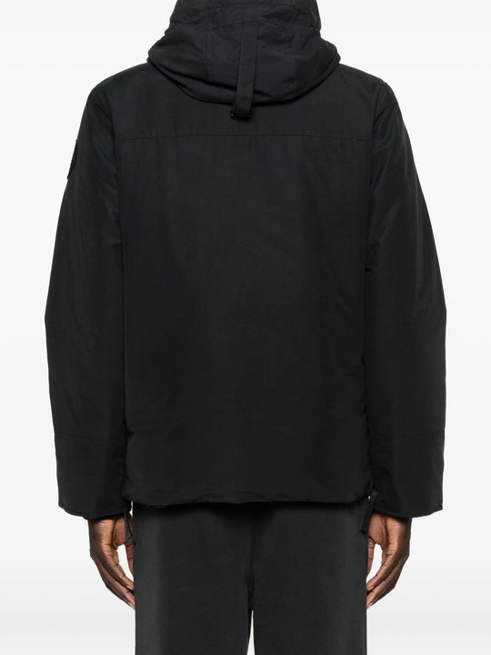 Black coat  worn by a person, showing the coat's fit