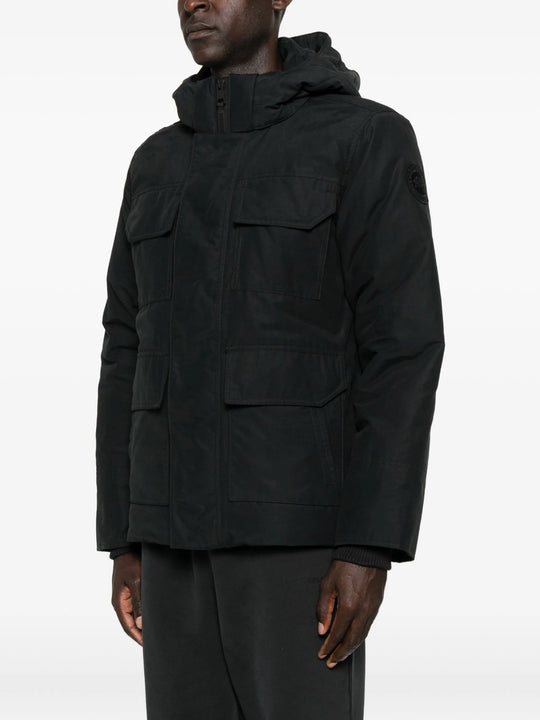 Black coat  worn by a person, showing the coat's fit