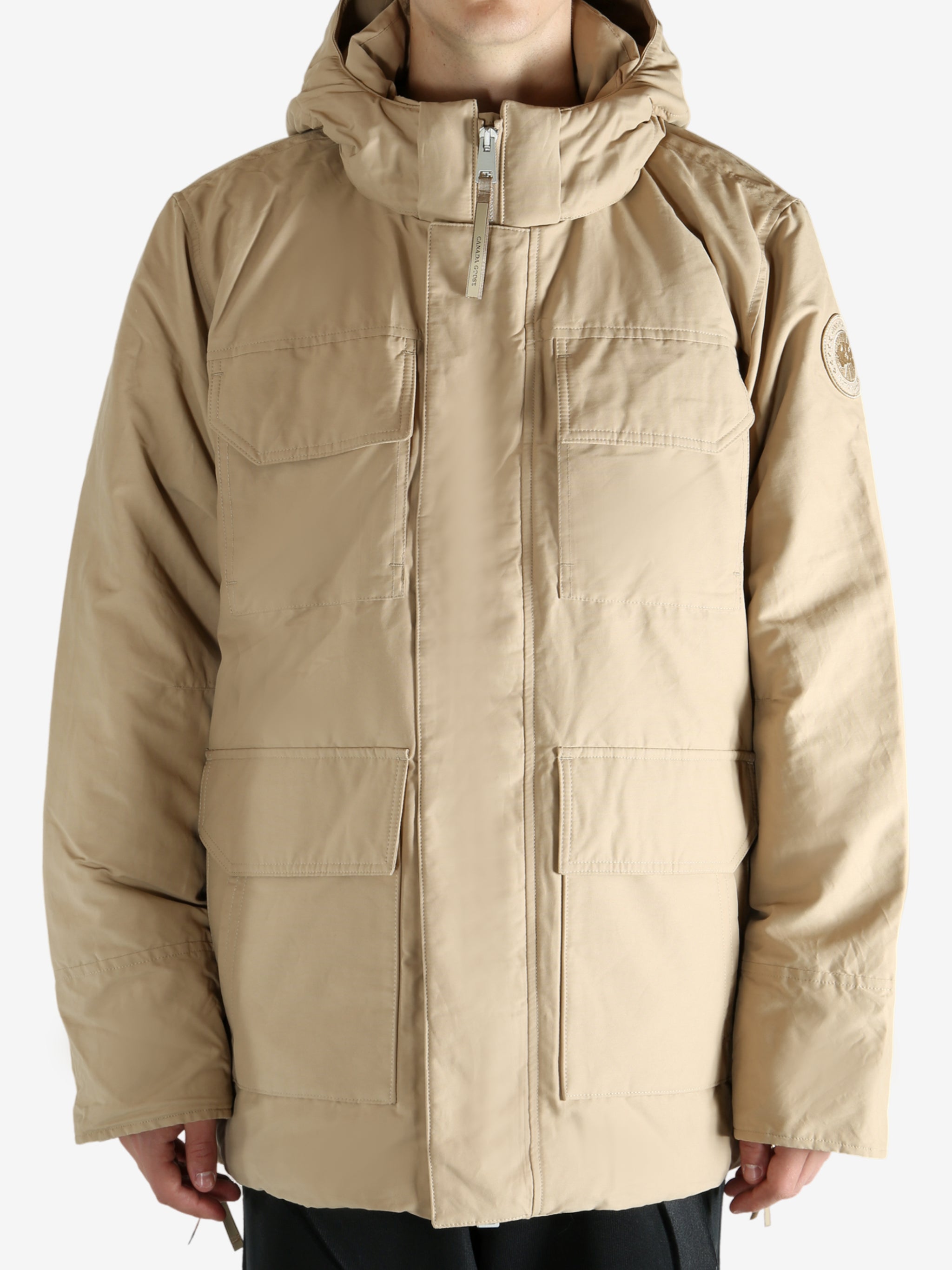 Tan coat worn by a  person, showing the coat's fit