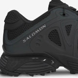 Close up of black sneakers, showing mesh upper