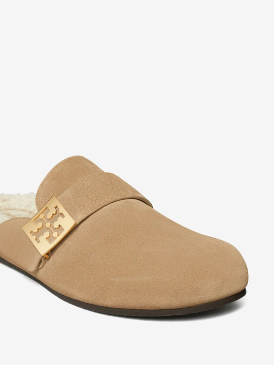 Close up of tan mules, showing texture of the suede fabric