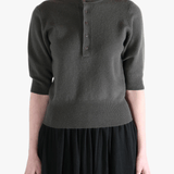 Dark gray sweater worn by a person, showing the sweater fit