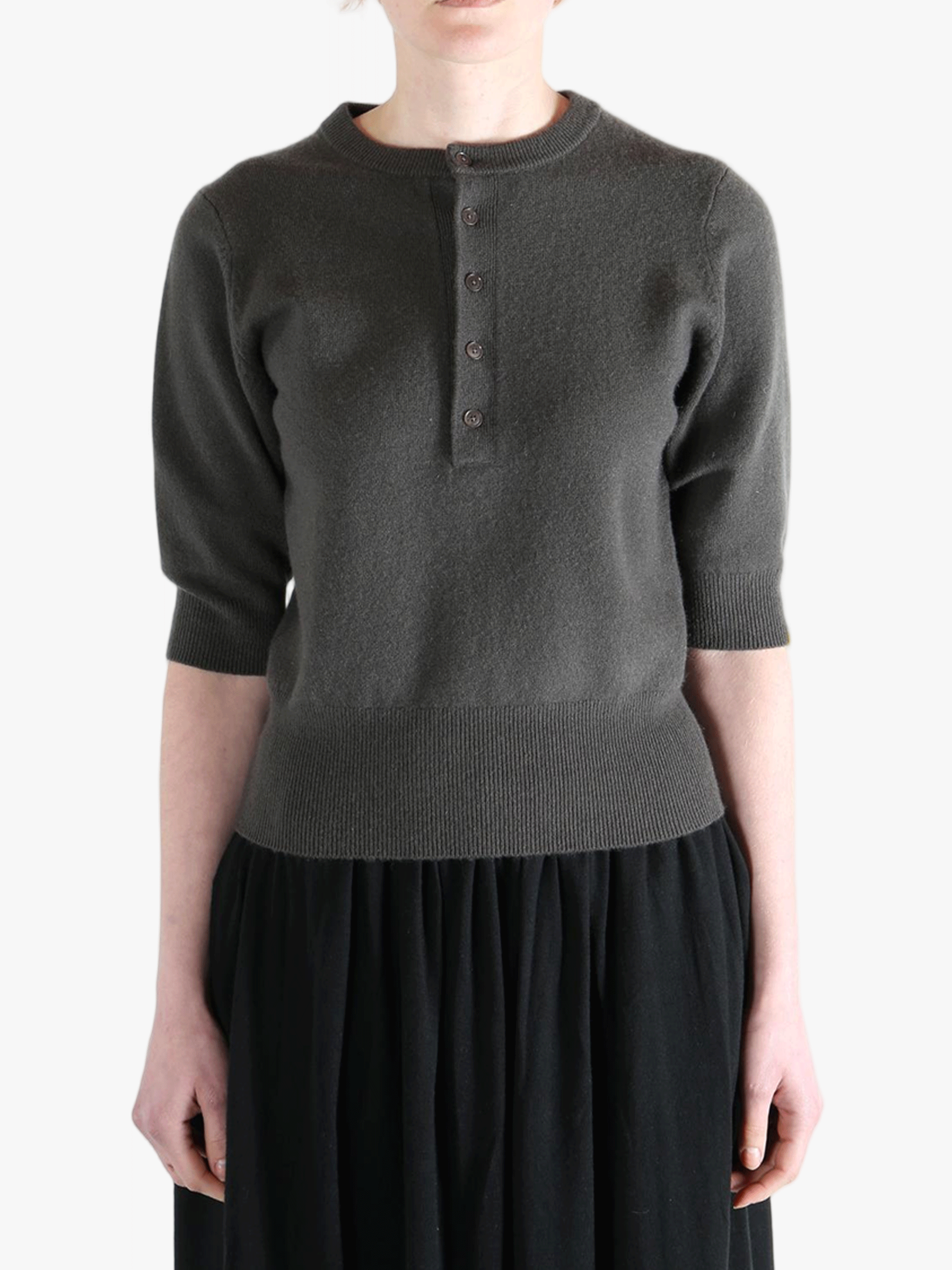 Dark gray sweater worn by a person, showing the sweater fit