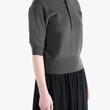 Dark gray sweater worn by a person, showing the sweater fit