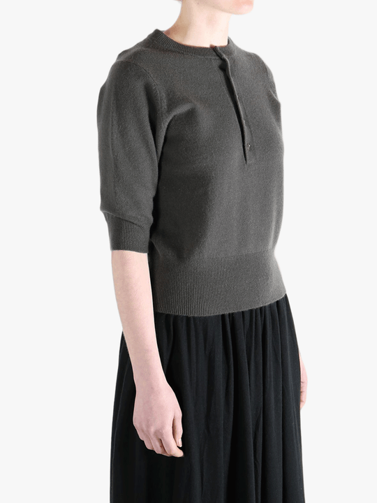 Dark gray sweater worn by a person, showing the sweater fit