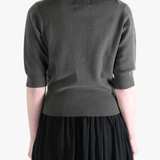 Dark gray sweater worn by a person, showing the sweater fit