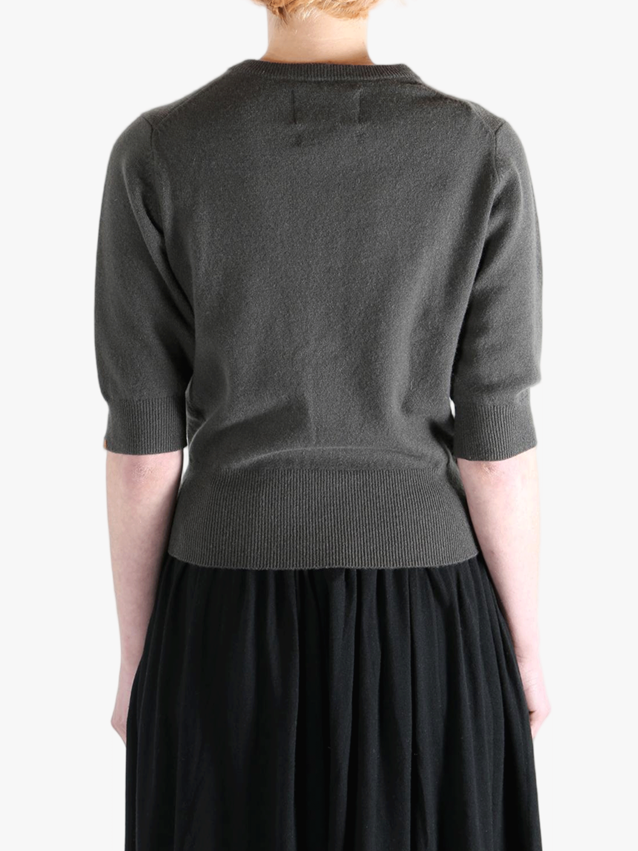 Dark gray sweater worn by a person, showing the sweater fit