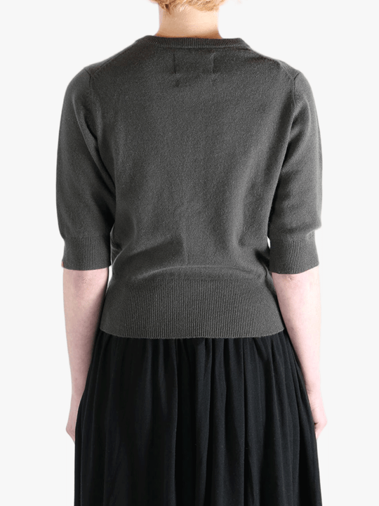 Dark gray sweater worn by a person, showing the sweater fit