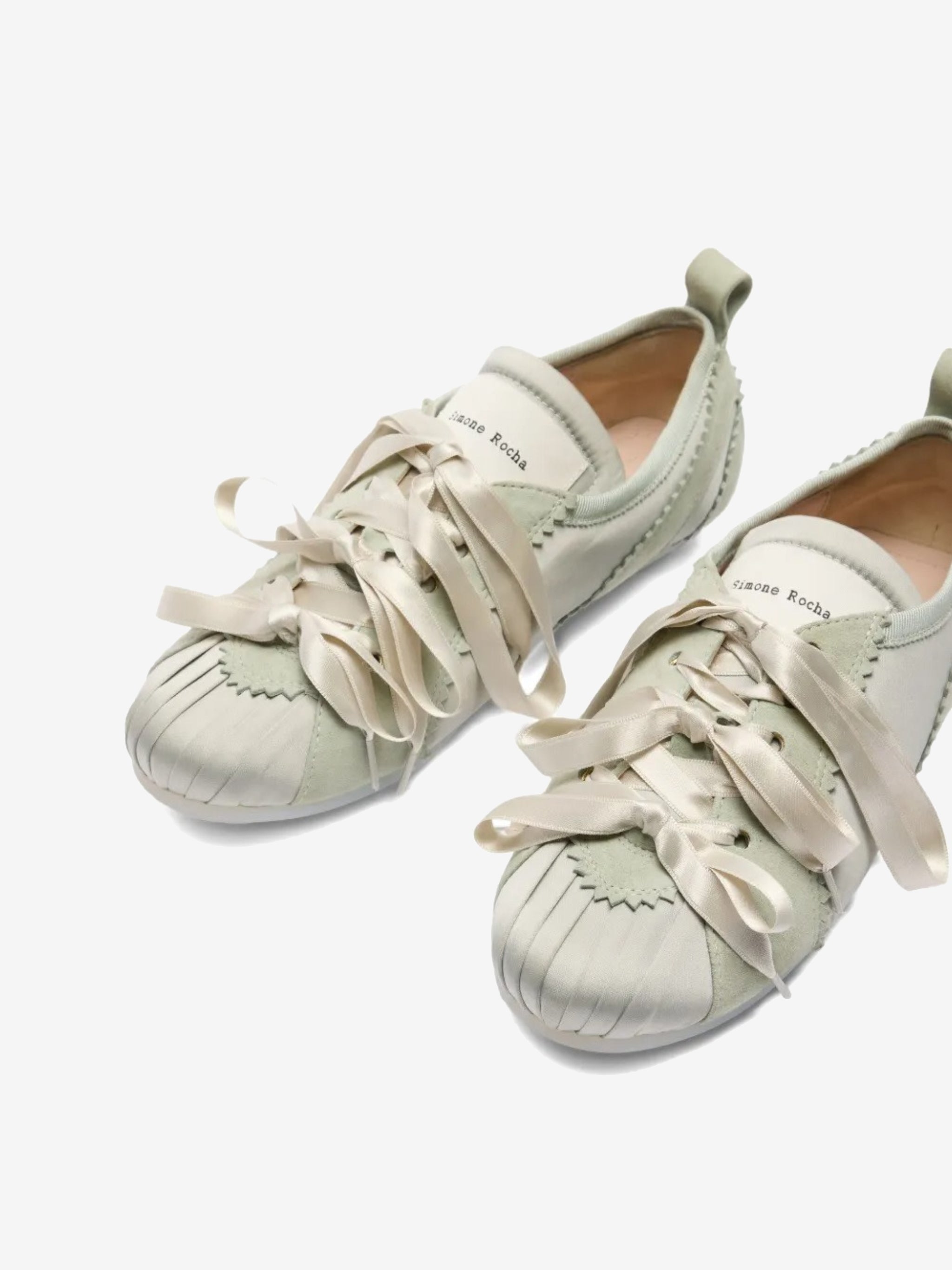 Close up of the green shoes, showing texture of the polyester and leather fabric