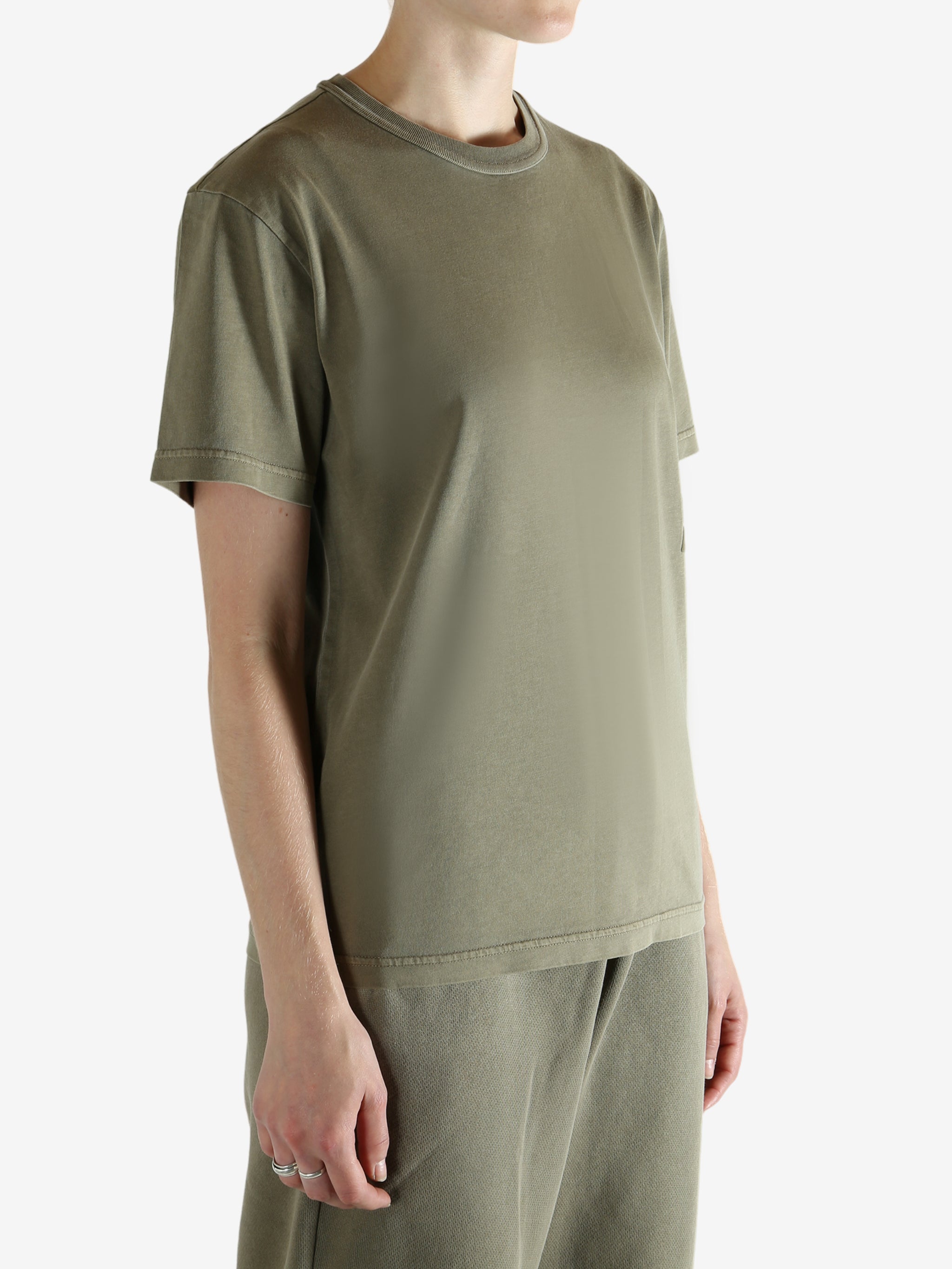 Brown t-shirt worn by a person, showing the t-shirt fit