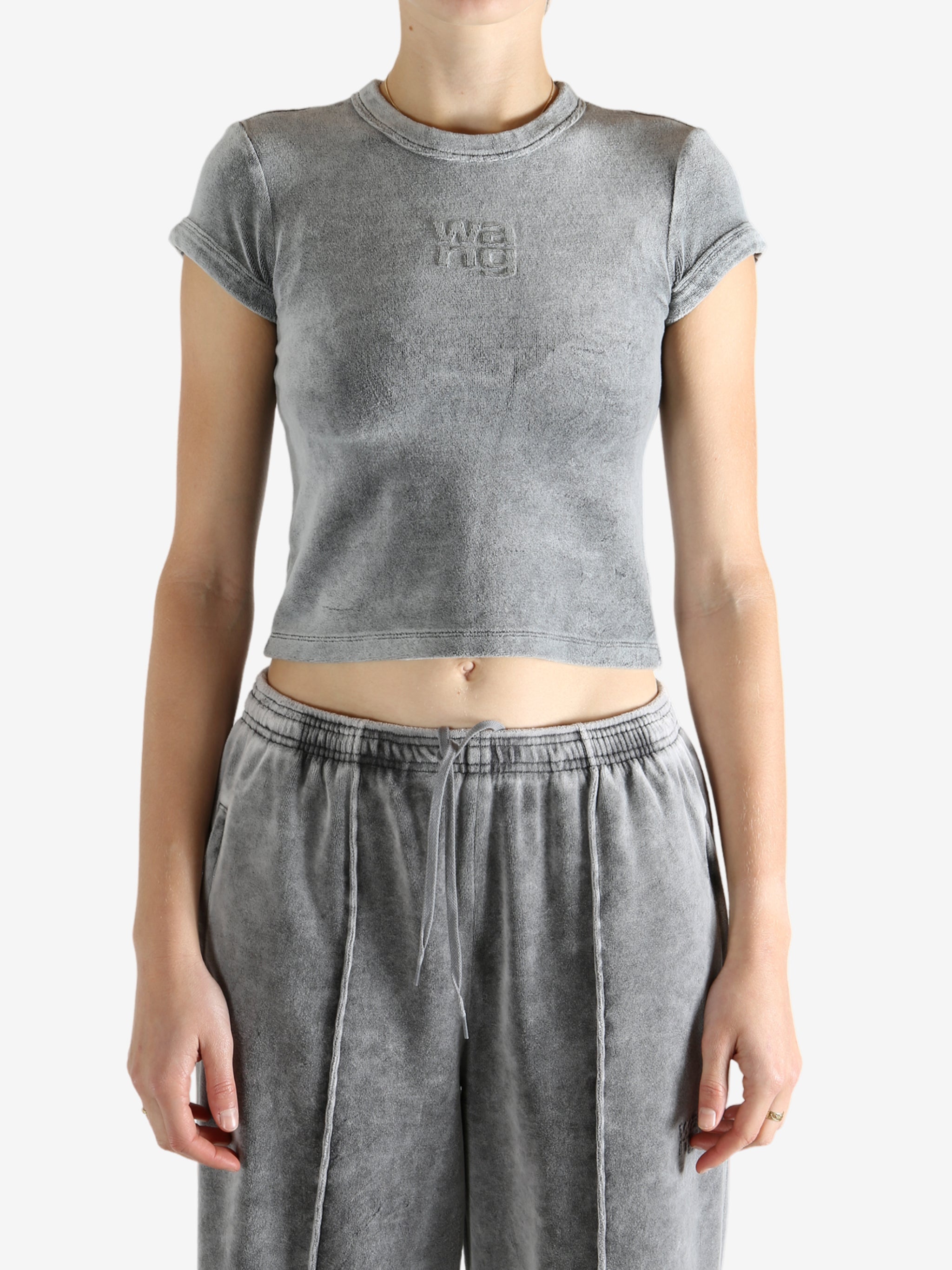 Grey t-shirt worn by a person, showing the t-shirt's fit