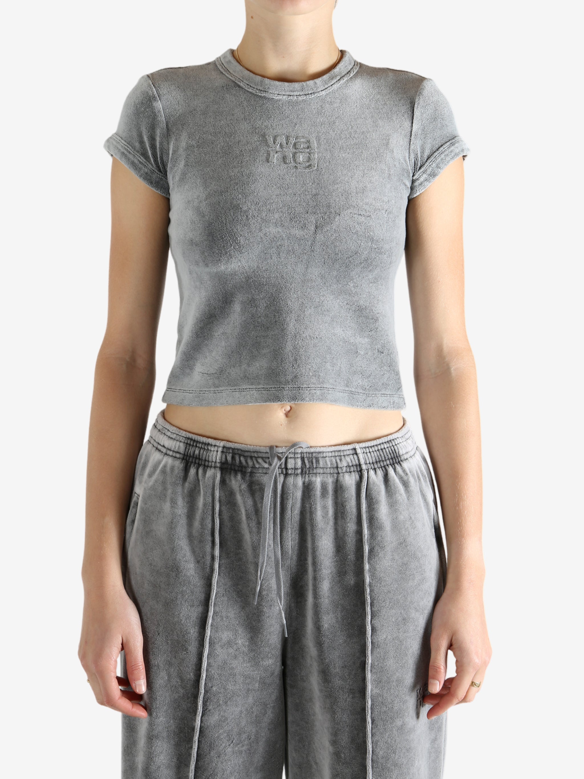 Grey t-shirt worn by a person, showing the t-shirt's fit