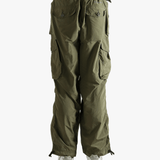 Green pants worn by a person, showing the pants fit